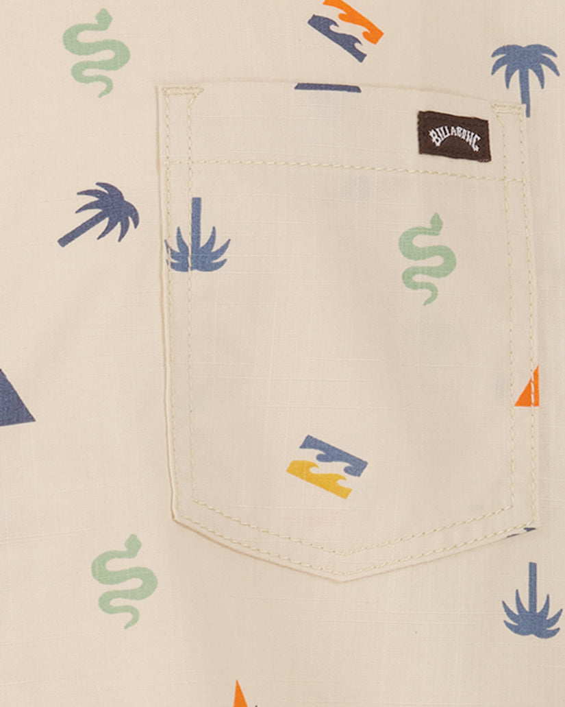 Cream short sleeve shirt with scattered blue palm trees, green snakes, orange triangles, and yellow lightning bolt print, fea