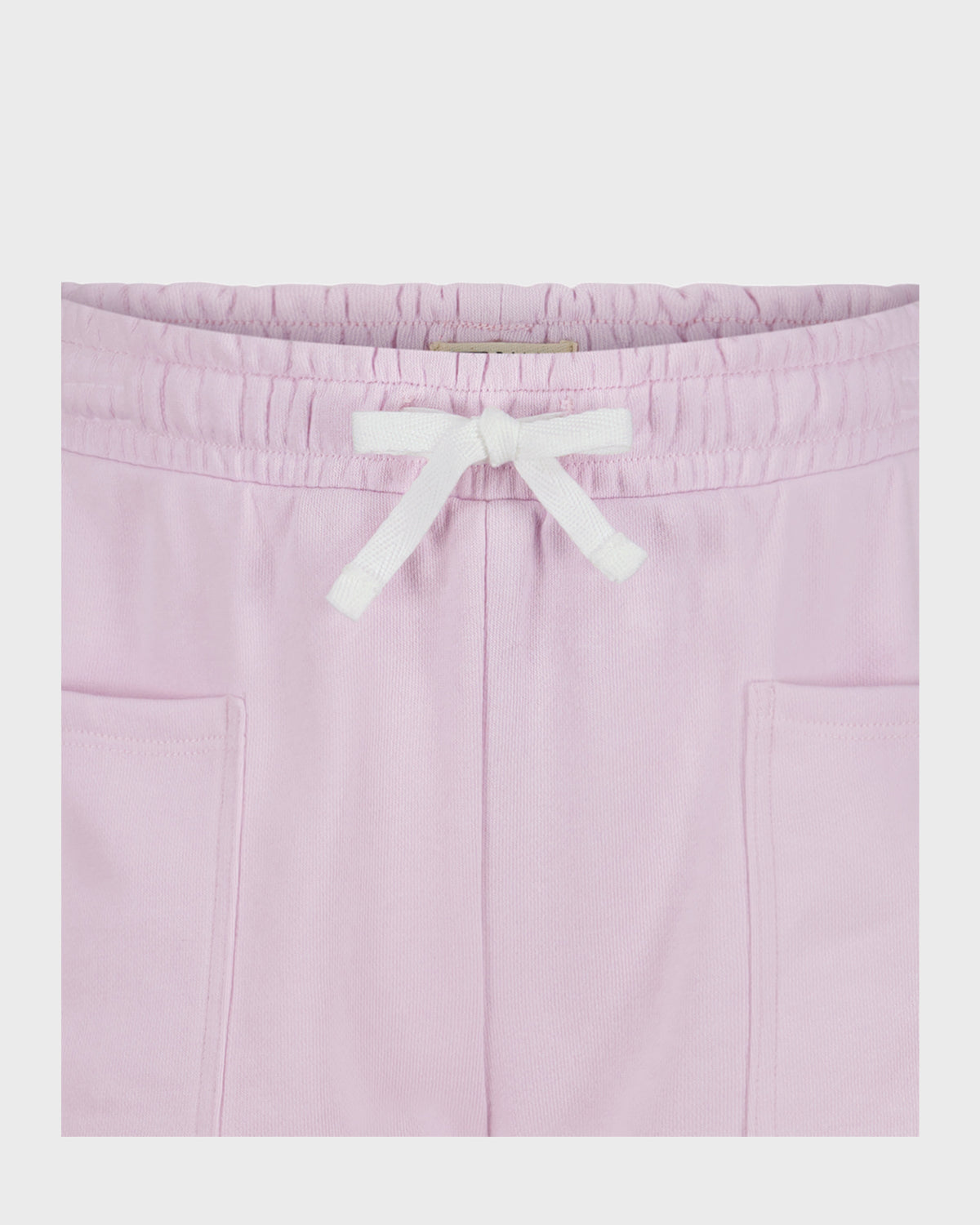 Light pink short with white drawstring waistband and side pockets, flat lay front view.