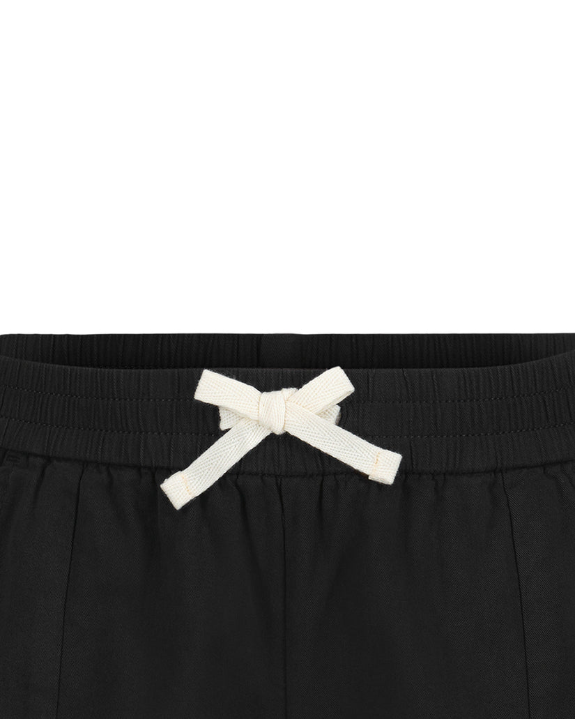 Black shorts with ribbed elastic waistband and white drawstring bow.
