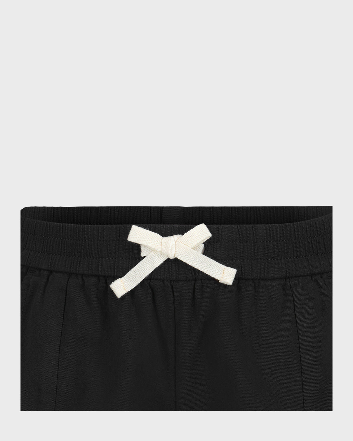 Black shorts with ribbed waistband and white drawstring bow tie.