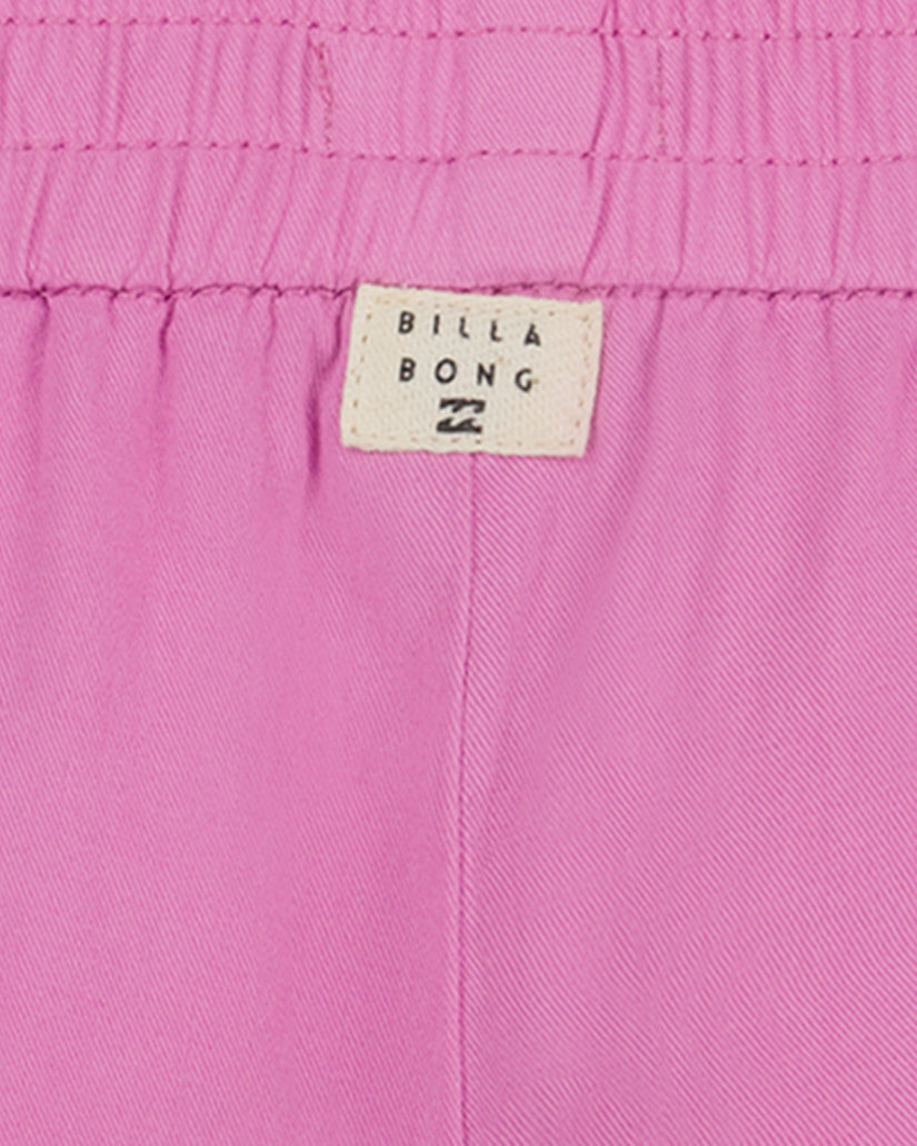Pink Billabong shorts with elastic waistband and brand label visible.