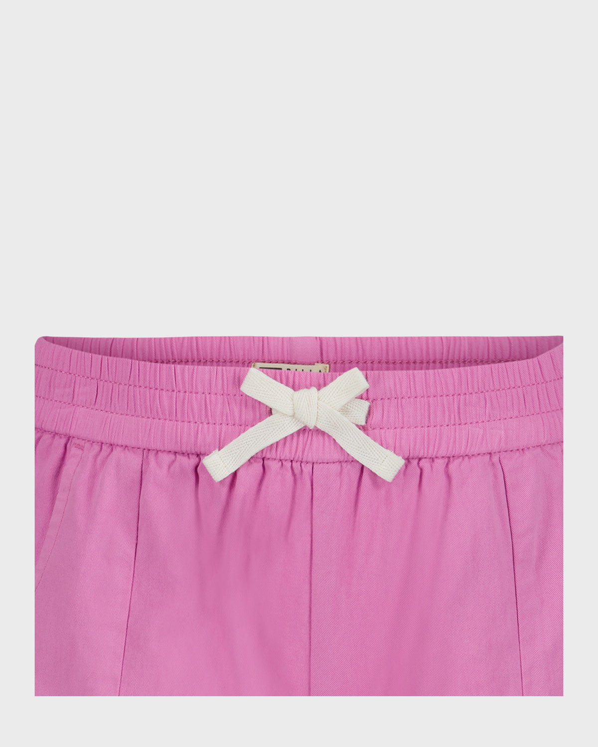 Pink shorts with white drawstring bow and elasticated waistband.