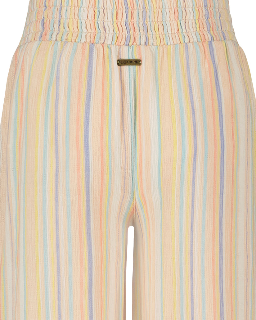 Wide-leg pants with pastel vertical stripes in pink, yellow, blue, and green on cream background with smocked waistband.