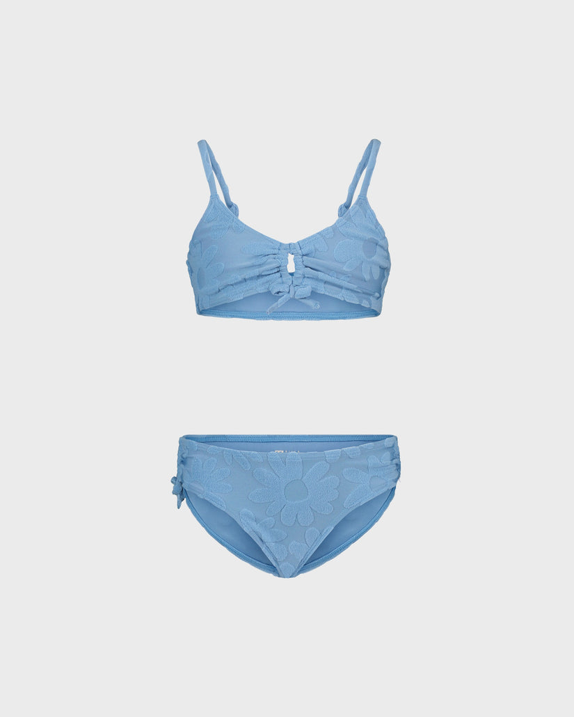 Blue bikini set on a light gray background
