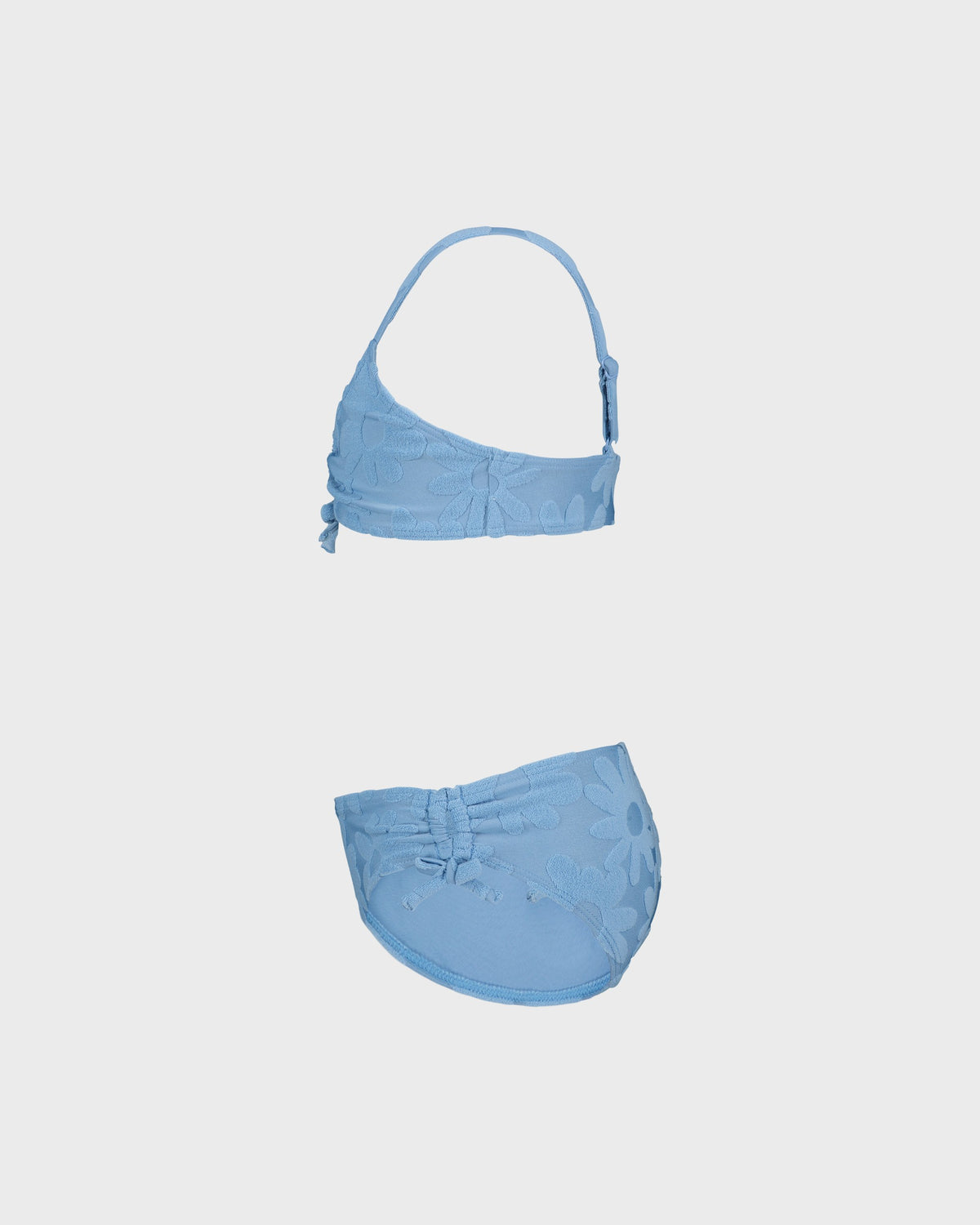Blue bikini set on a light gray background