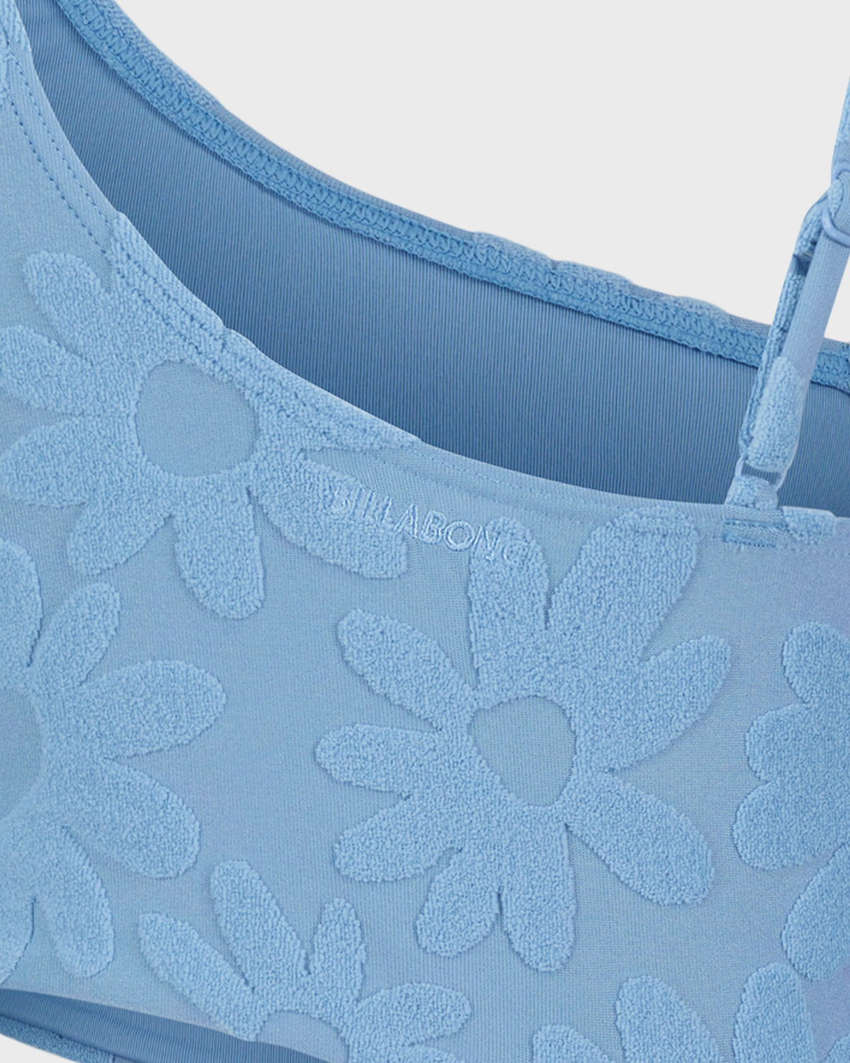 Blue lace bra with floral patterns and 'SILKADO' branding.