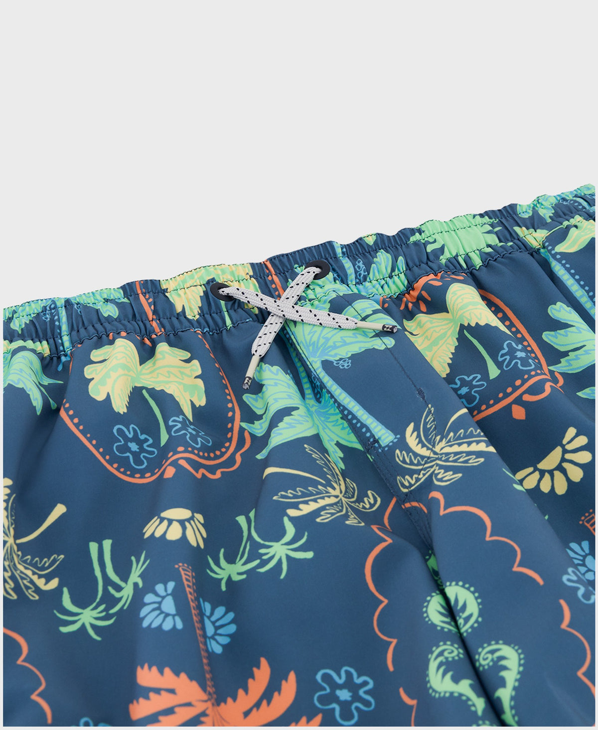 Navy swim trunks with colorful botanical print in green, yellow, and orange, featuring elastic waistband with white drawstrin