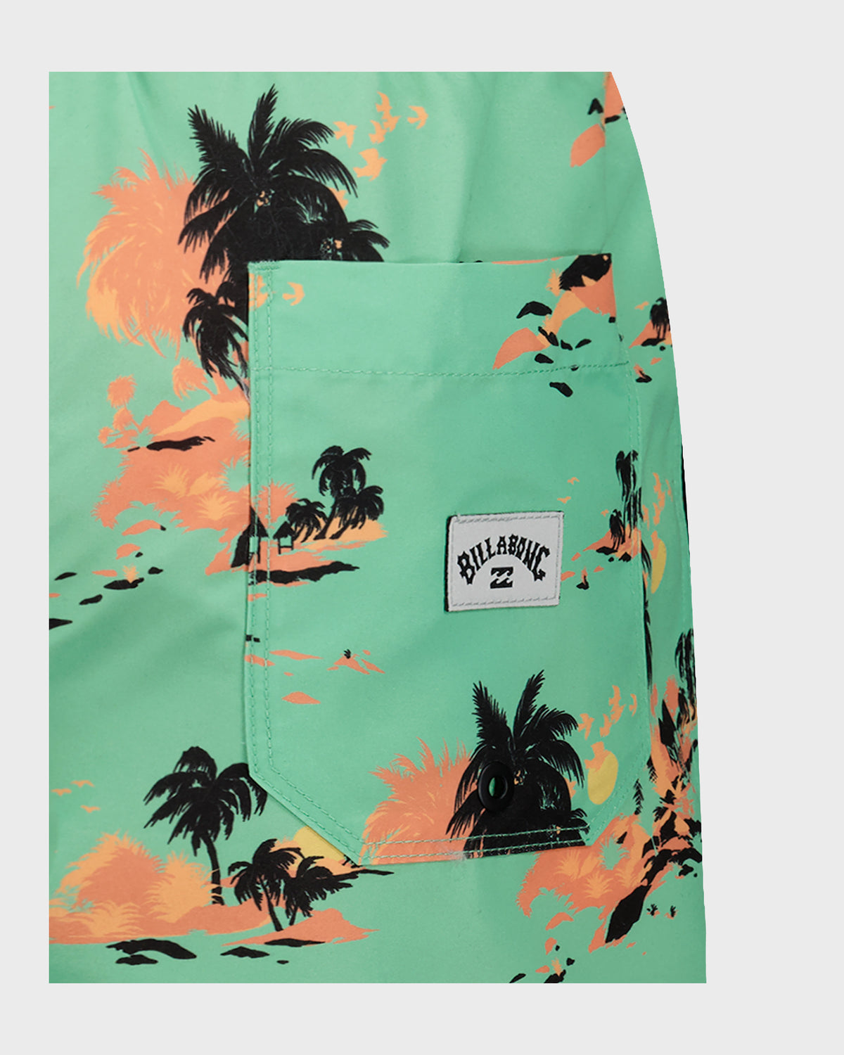 Mint green swim trunks with black palm trees and orange sunset print, front patch pocket with Billabong logo.