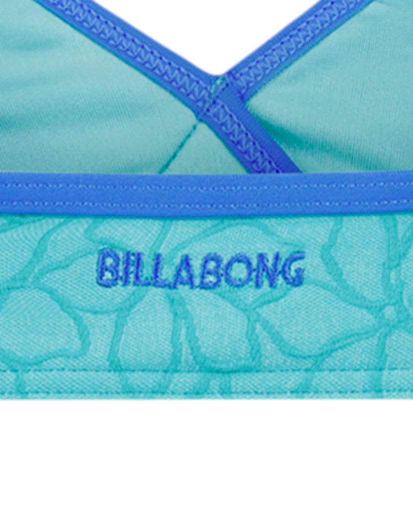 Turquoise and blue Billabong bikini top with cross straps and textured leaf pattern fabric.