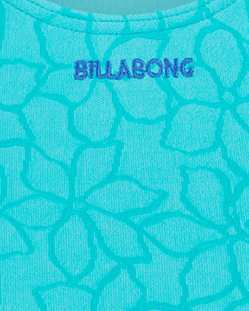 Turquoise one-piece swimsuit with geometric scale pattern and Billabong branding on chest.