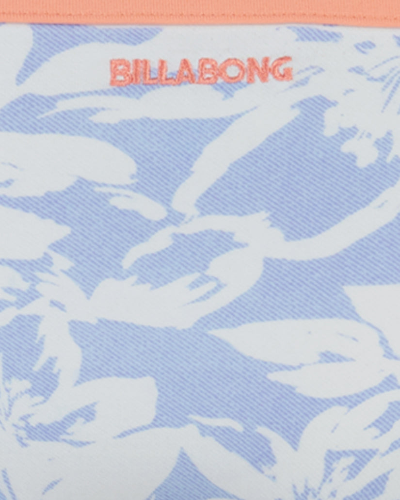 Billabong bikini fabric with blue and white abstract wave pattern and coral-colored brand logo.