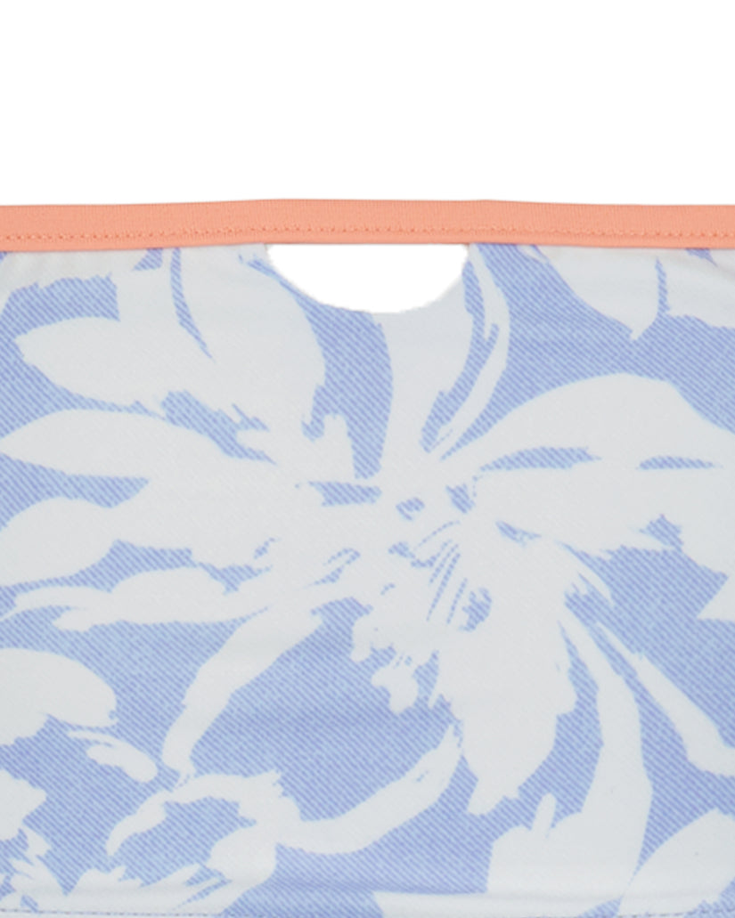Bikini top with peach trim and blue and white abstract leaf pattern.