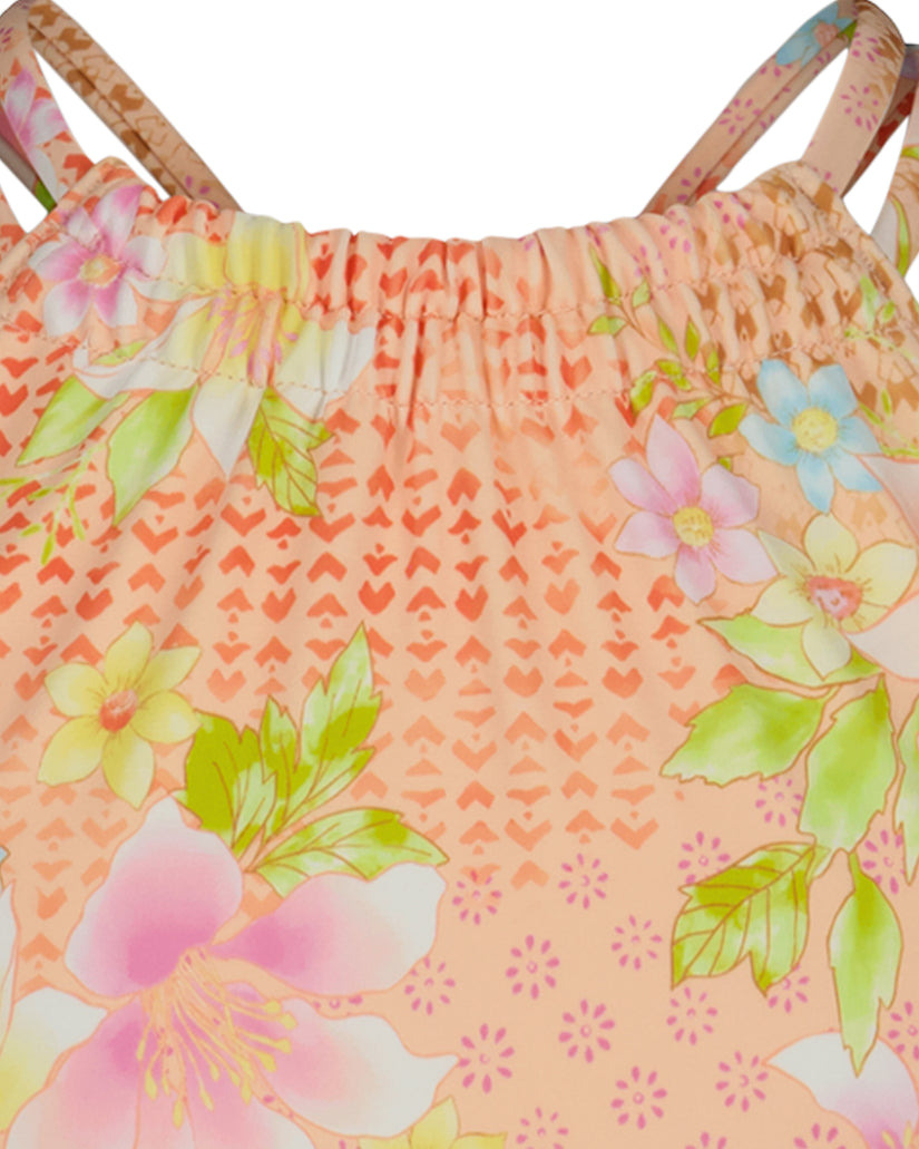 Coral bikini top with multicolored floral and geometric heart pattern, adjustable shoulder straps, and ruched front detail.