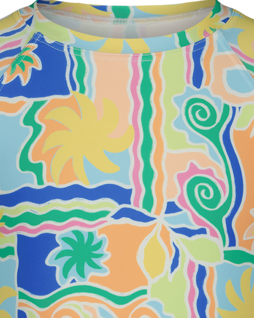Girls' crop rashguard with multicolored abstract print featuring suns, spirals, and wavy stripes in yellow, blue, green, and 