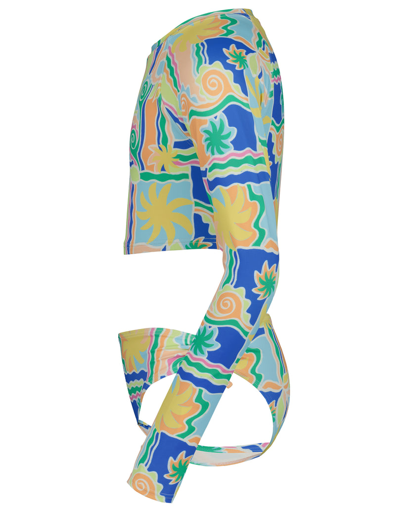 Colorful rashguard with blue, yellow, green, and peach abstract floral and geometric print, shown flat lay from side angle.