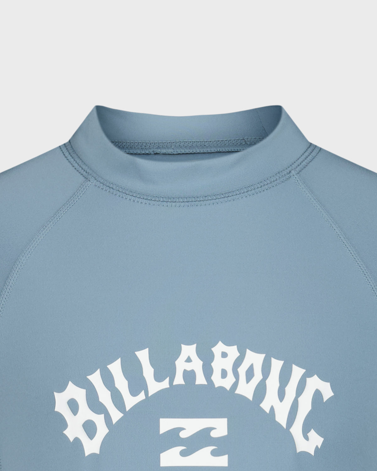 Blue long sleeve rashguard with white "Billabong" text and logo on chest, crew neckline visible.
