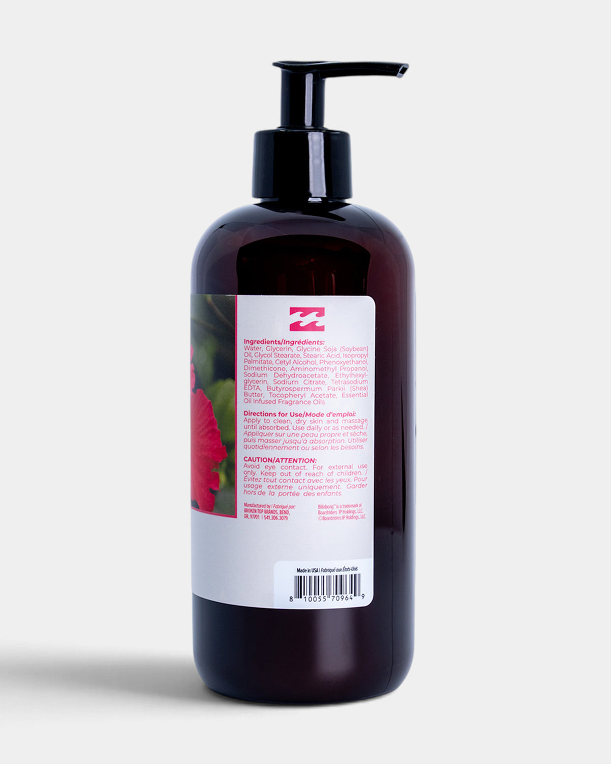 Dark amber bottle with black pump dispenser and white label featuring pink hibiscus flower imagery and product information.