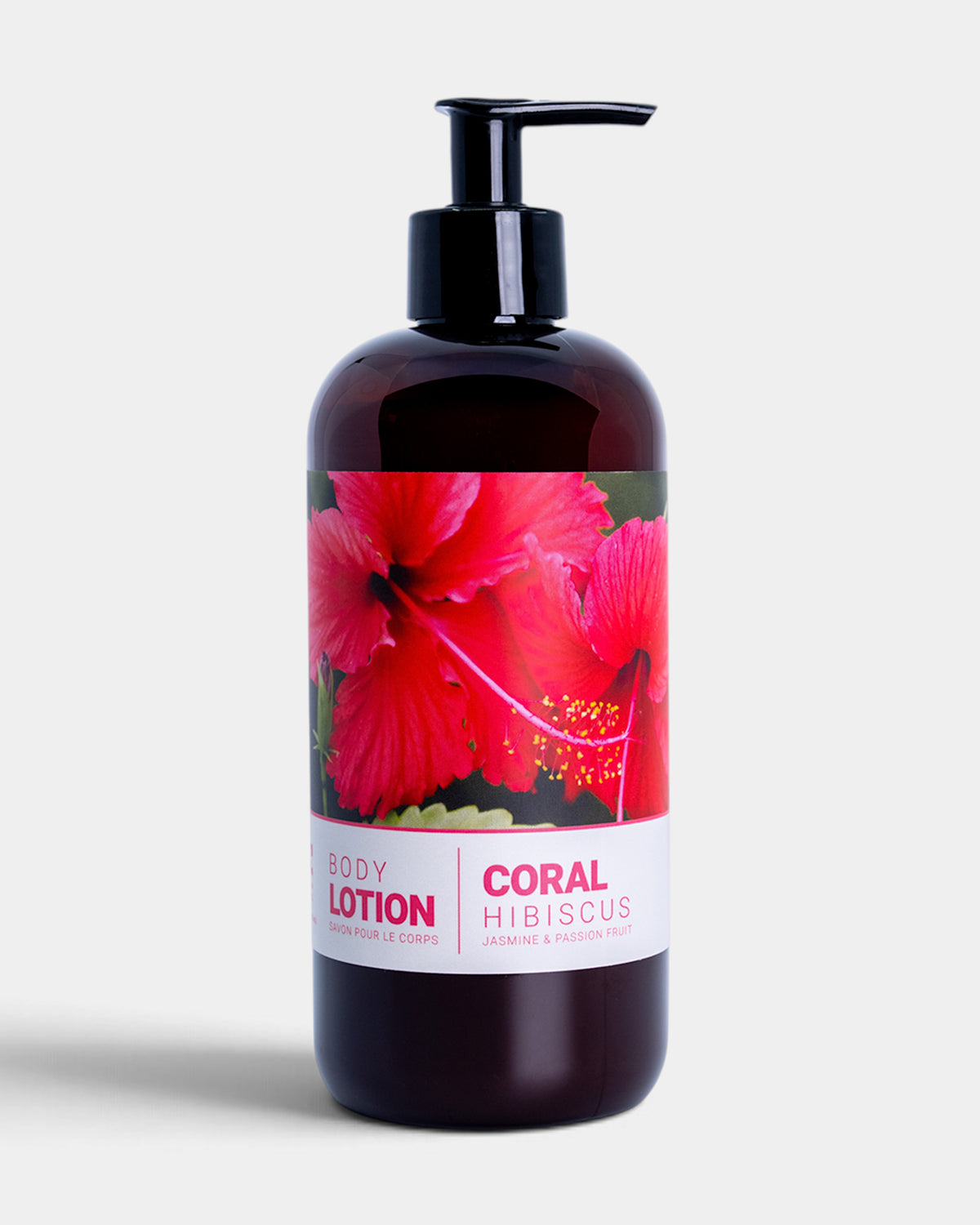 Dark glass pump bottle containing coral-colored lotion with red hibiscus flower label and text.