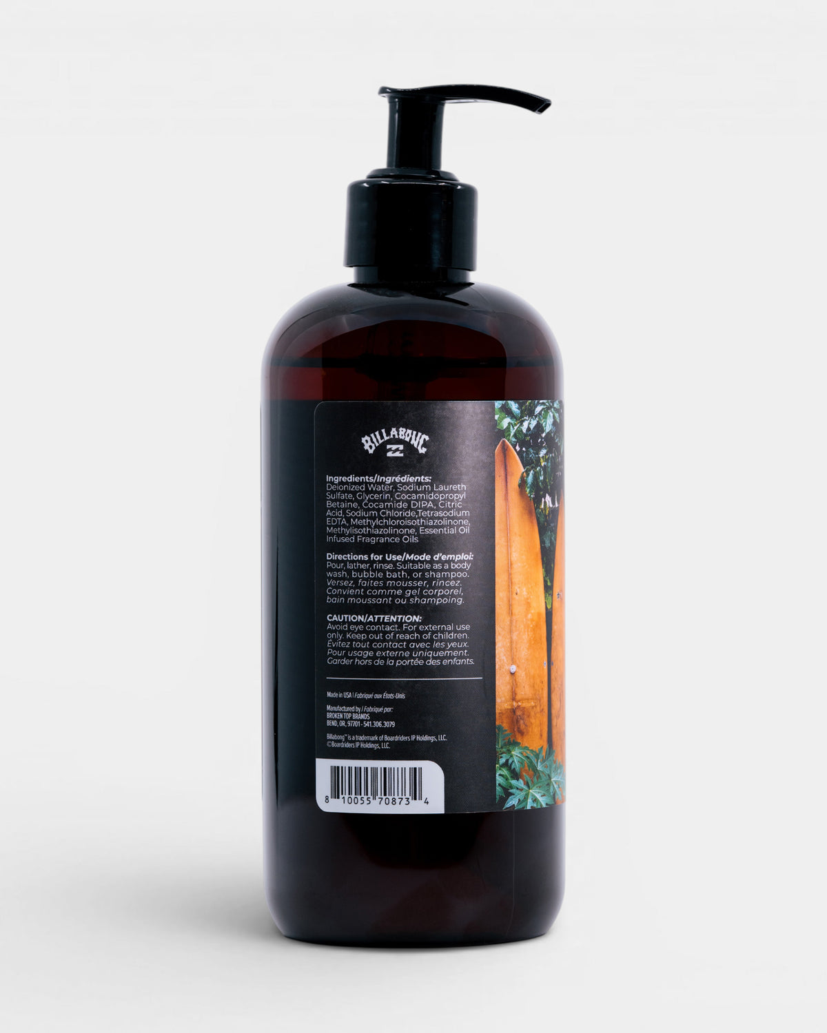 Dark amber bottle with black pump dispenser and label featuring orange surfboard imagery.