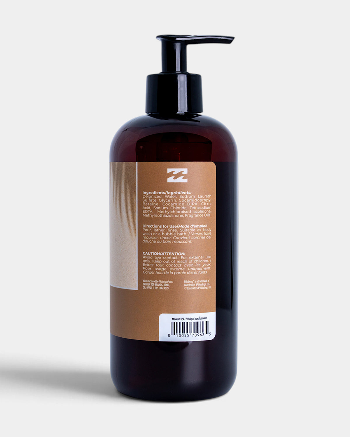Dark glass bottle with black pump dispenser and tan label containing product ingredients and usage directions.