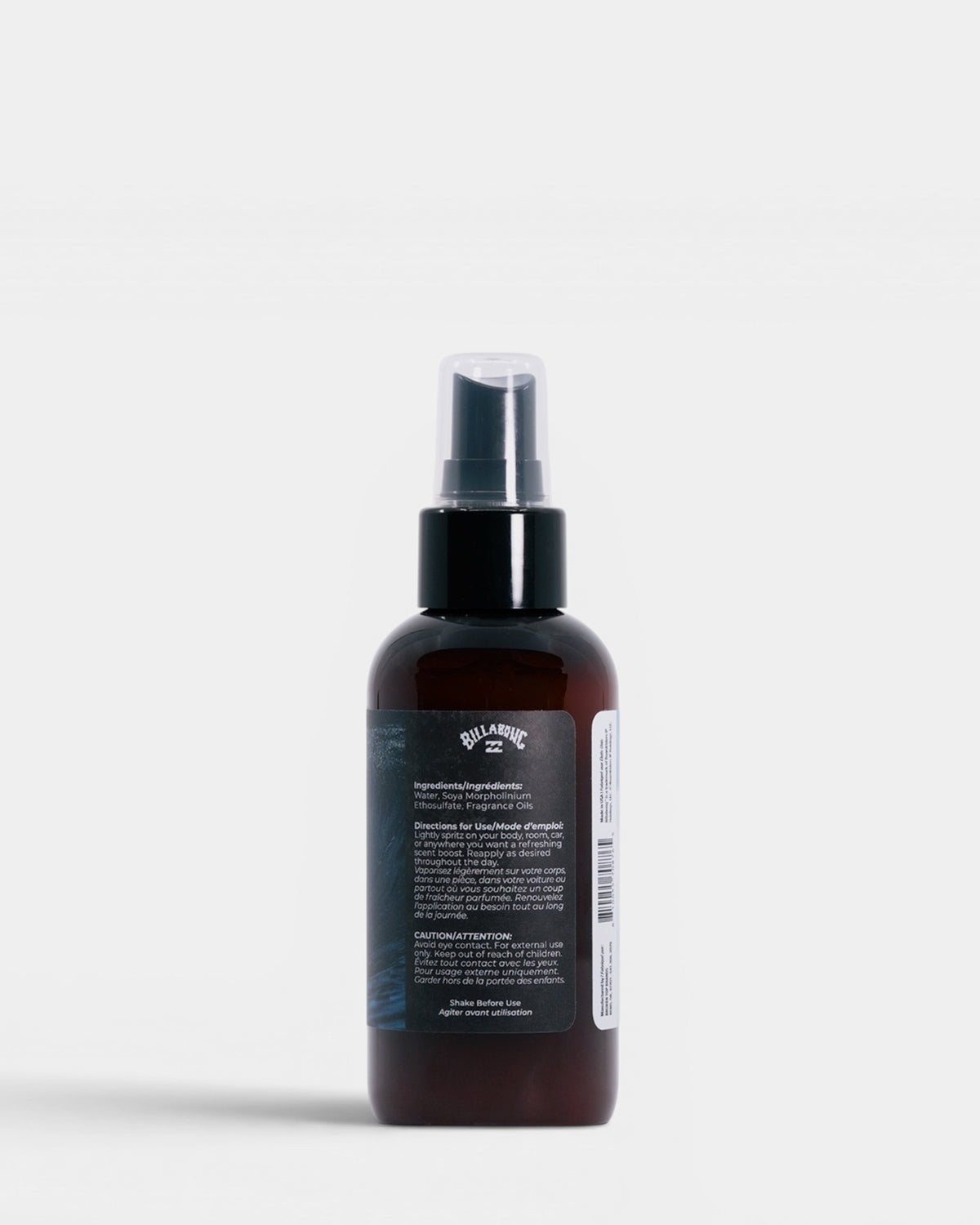 Dark amber spray bottle with black pump top and product label containing ingredients and usage directions.