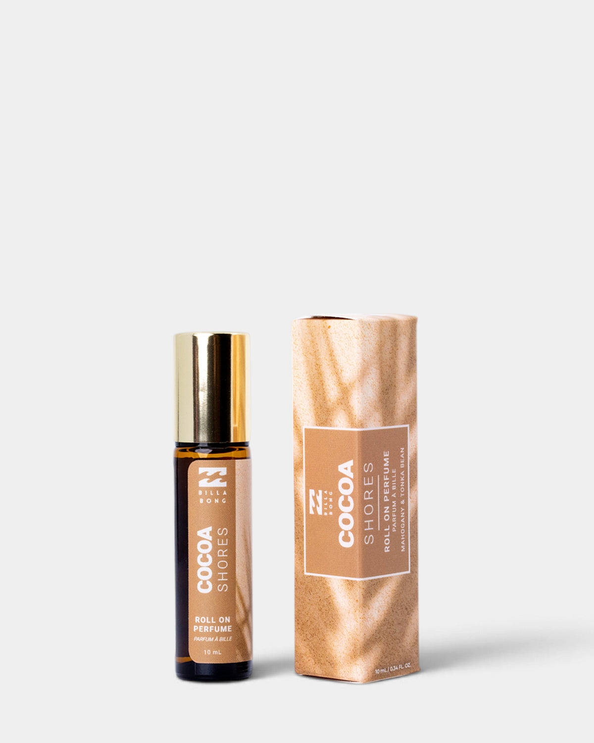 Brown glass roll-on perfume bottle with gold cap next to rose gold textured box packaging.