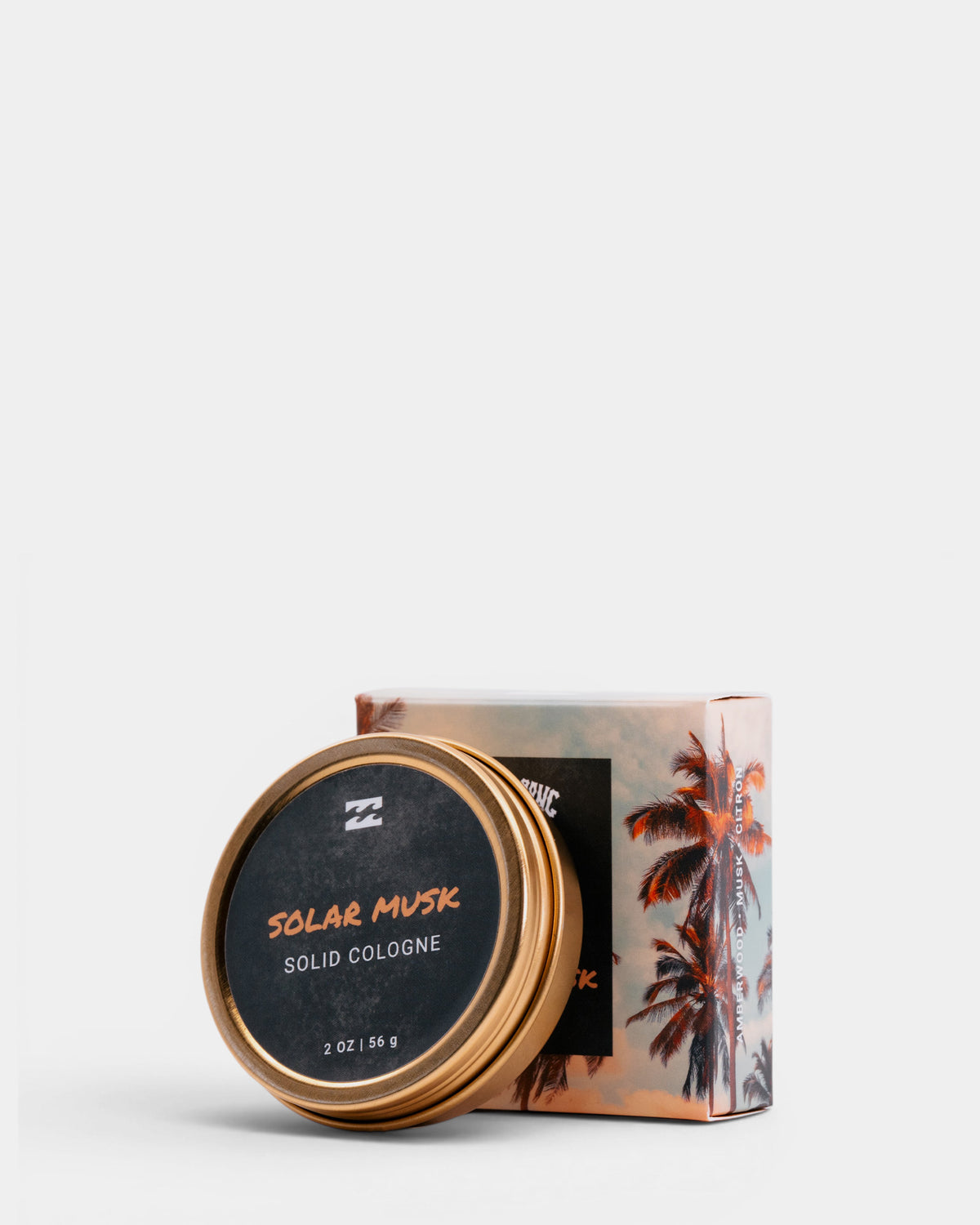 Gold-rimmed tin container labeled "Solar Musk Solid Cologne" next to palm tree-printed box packaging.
