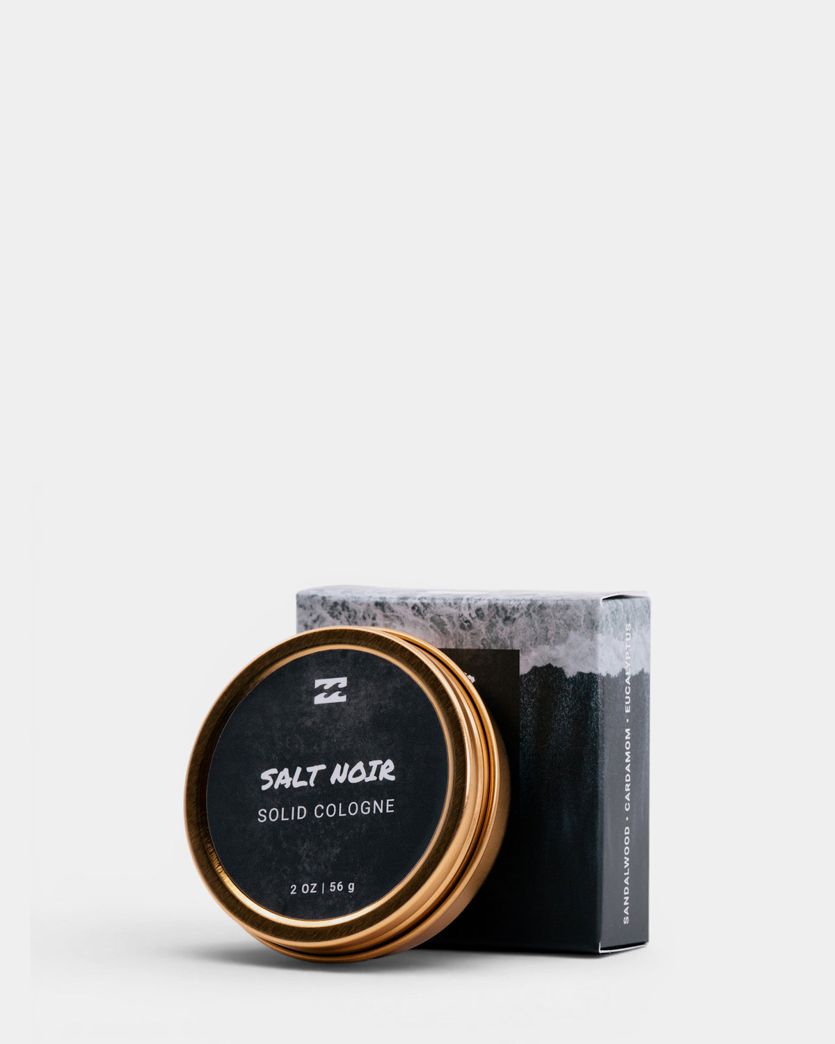 Round metal tin with black label reading "Salt Noir Solid Cologne" next to its rectangular cardboard box on white background.