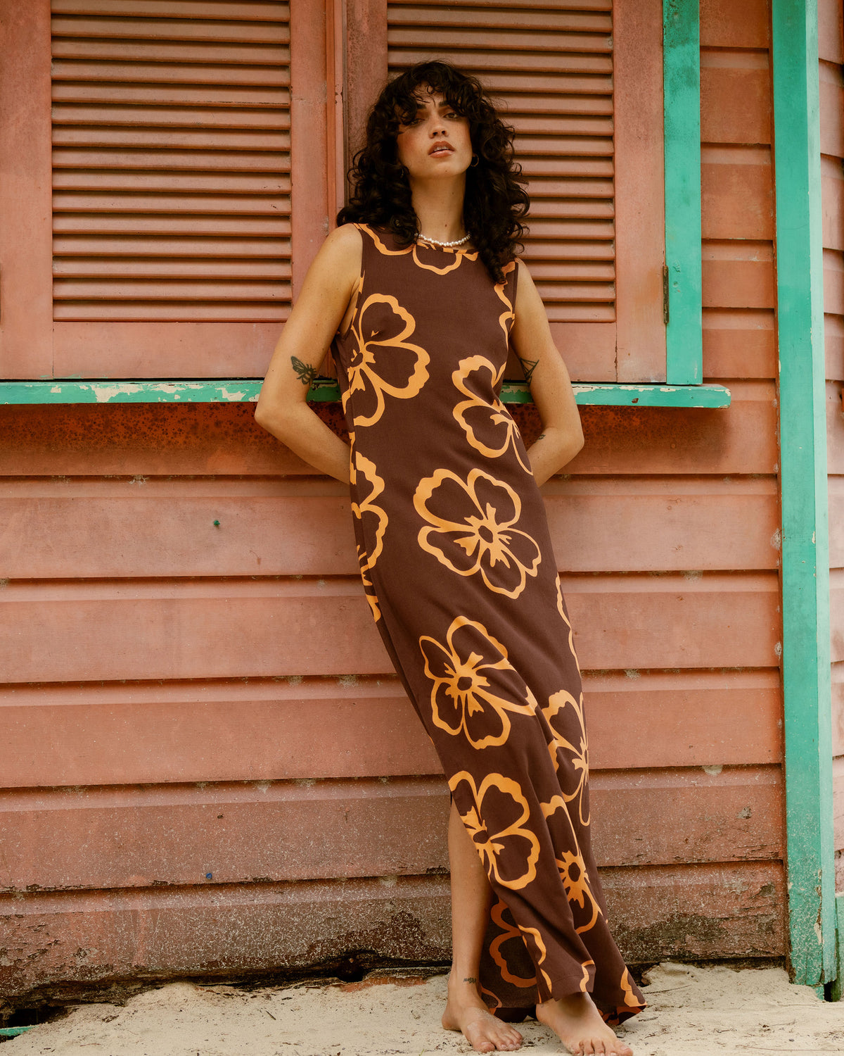 Teak maxi dress with large golden flower print, sleeveless, ankle-length.