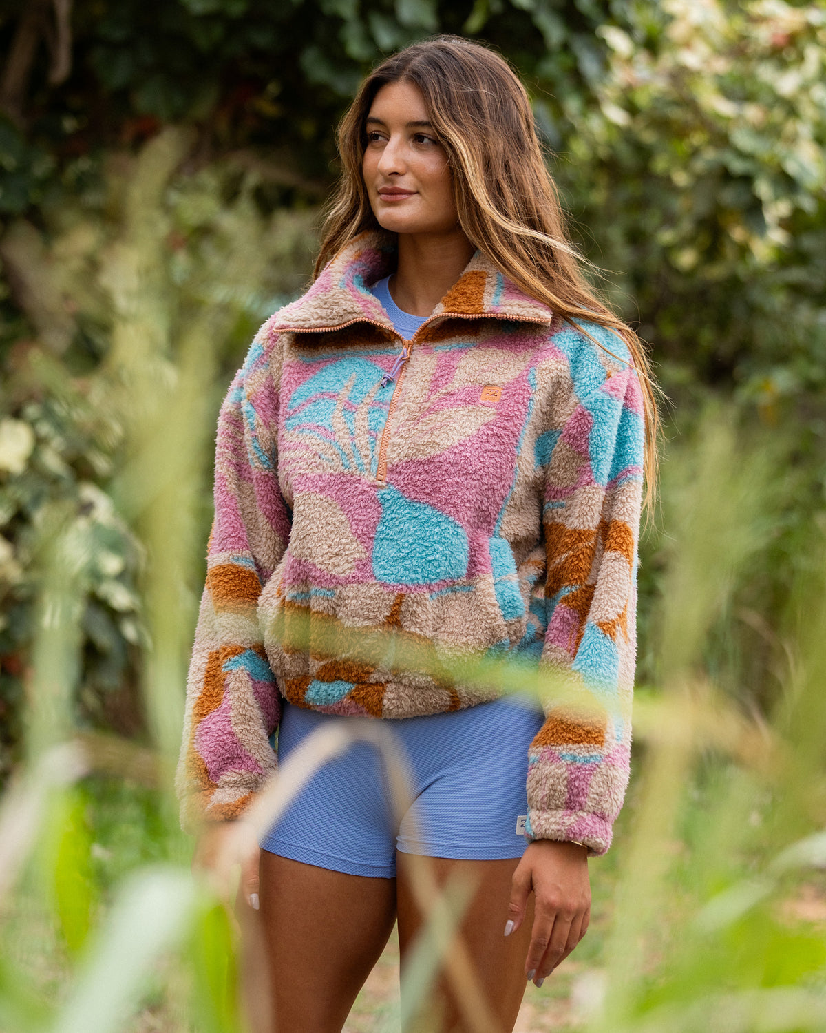 Oatmeal sherpa fleece half zip pullover with multicolored geometric block pattern in pink, blue, and orange.